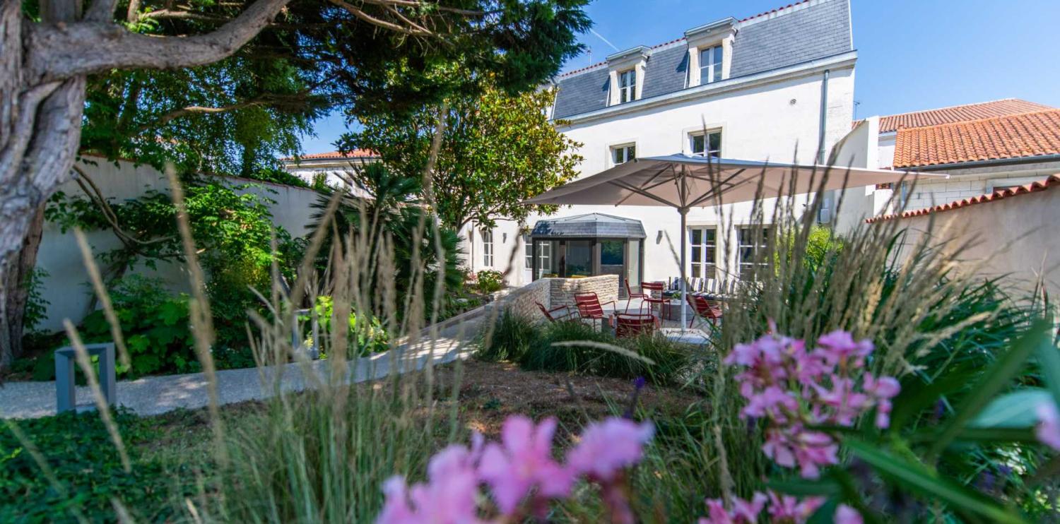 vue extérieure de la maison saint nicolas entouré de verdure et de fleurs