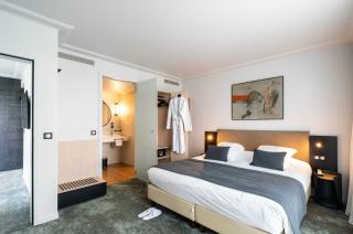chambre d'hôtel lumineuse et spacieuse avec un grand lit, décorée dans un style contemporain